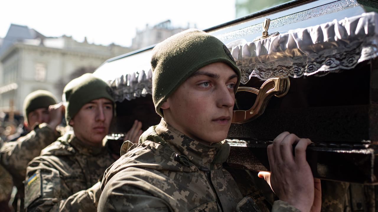 Ukrainian servicemen carry a coffin during the funeral service for four of their comrades, who were killed by a Russian air strike. Picture: Getty Images