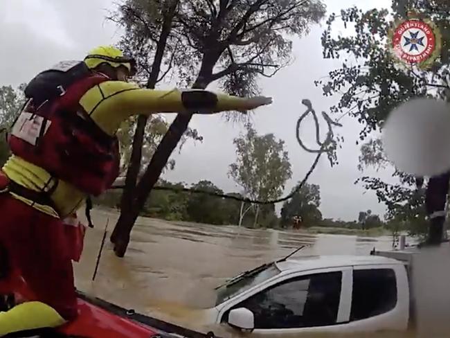 Swift water rescue crews rescued a driver stranded on his ute's roof after his vehicle was swept of the roadway at Balyendo crossing. Image: QFD