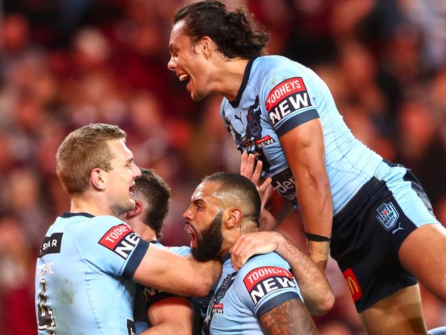 BRISBANE, AUSTRALIA - JUNE 27: Tom Trbojevic of the Blues celebrates after scoring a try with James Tedesco, Josh Addo-Carr and Jarome Luai of the Blues during game two of the 2021 State of Origin series between the Queensland Maroons and the New South Wales Blues at Suncorp Stadium on June 27, 2021 in Brisbane, Australia. (Photo by Chris Hyde/Getty Images)