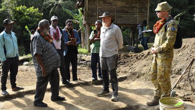 Australian and PNG officials at the site of a wartime cemetery at Templeton’s Crossing on the Kokoda Track, where the remains of Australian soldiers have been found. Picture: Department of Defence