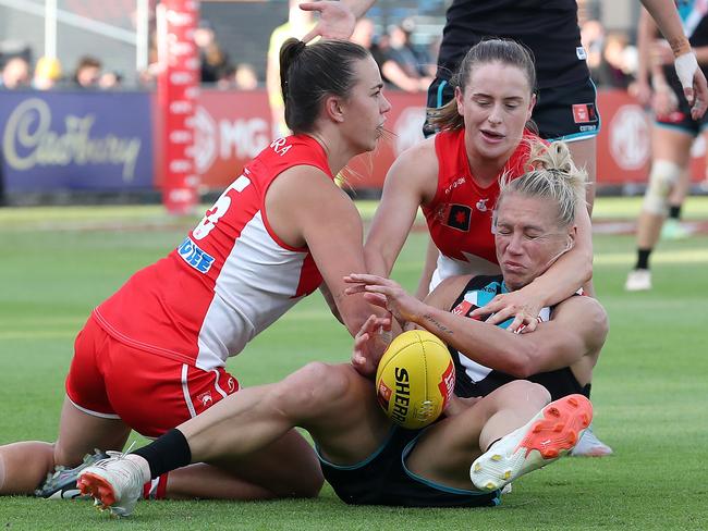 Laura Gardiner and Chloe Molloy combine to get Erin Phillips to the ground. Picture: Sarah Reed/AFL Photos via Getty Images