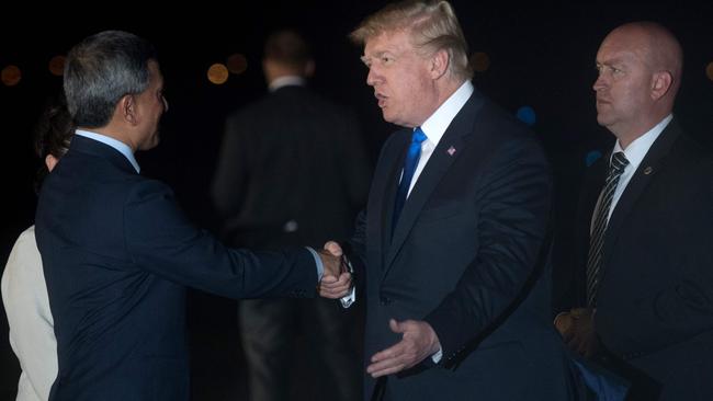 Donald Trump is welcomed by Singapore's Foreign Minister Vivian Balakrishnan after Air Force One arrives at Paya Lebar Air Base in Singapore.Picture: AFP.