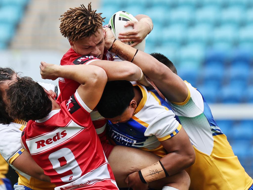 NRL National Schoolboys Cup final at CBUS Stadium between Palm Beach Currumbin and Patrician Blacktown Brothers. Palm Beach Currumbin's Jac Finigan driven back by Patrician Blacktown Brothers defence. .Picture Glenn Hampson