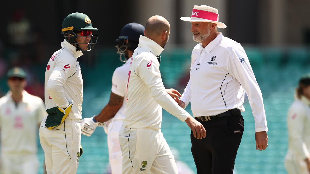 Tim Paine and Nathan Lyon of Australia question umpire Paul Wilson over a DRS referral against Cheteshwar Pujara.