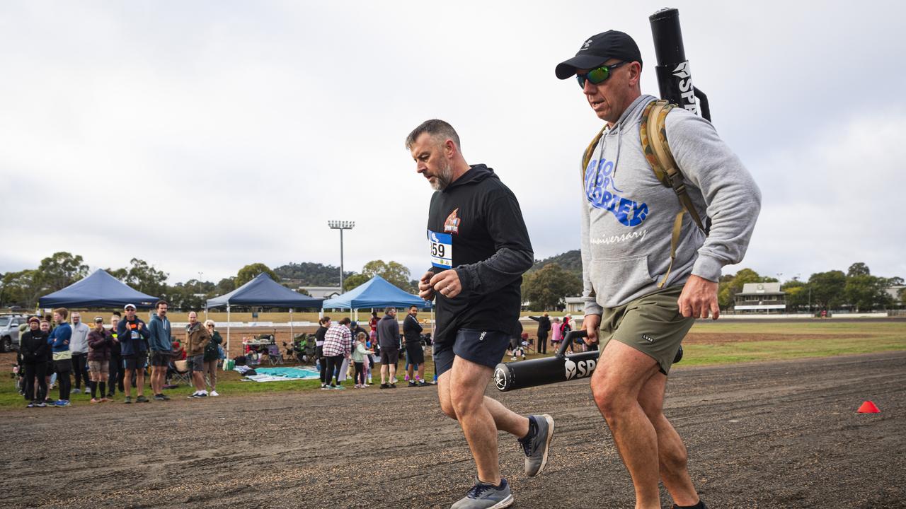 Spartans team members Des Brosnan (left) and Geordie Horn (carrying an extra 40kg) in 40 for Fortey at Toowoomba Showgrounds, Sunday, June 2, 2024. Picture: Kevin Farmer