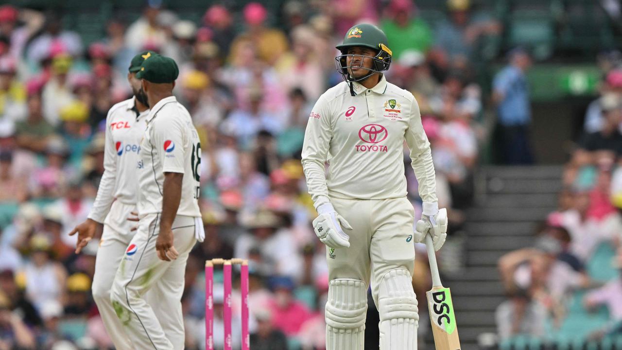 Australia’s batsman Usman Khawaja reacts after his dismissal during the second day of the third cricket Test match between Australia and Pakistan at the Sydney Cricket Ground in Sydney on January 4, 2024. (Photo by Saeed KHAN / AFP)