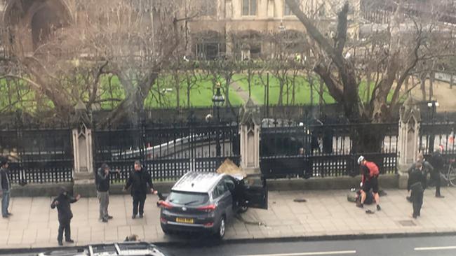 A car stopped on the sidewalk in front of the Palace of Westminster, which houses the Houses of Parliament, after in which pedestrians were hit.   Picture: AFP