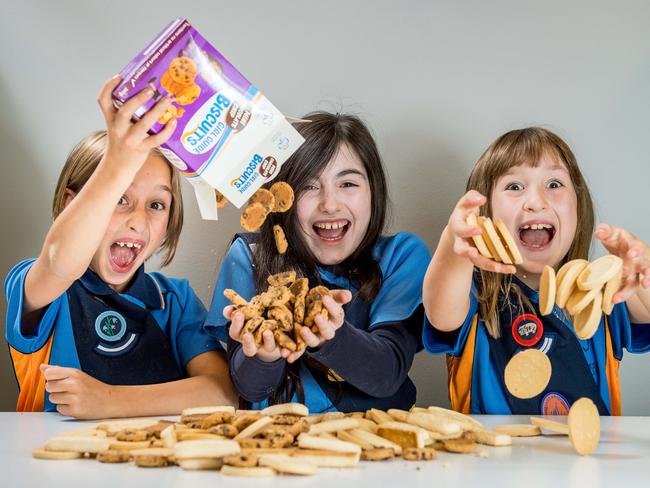 Girl Guides Helen, 8, Nora, 9, and Maggie, 8, are celebrating 60 years of the biscuit drive. Picture: Jake Nowakowski