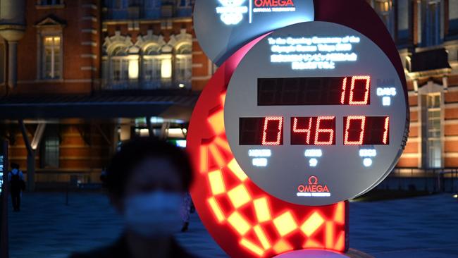 A woman walks in front of countdown clock for the Tokyo Olympics, which on Tuesday showed 10 days and 46 minutes to go to the opening ceremony. Picture: AFP