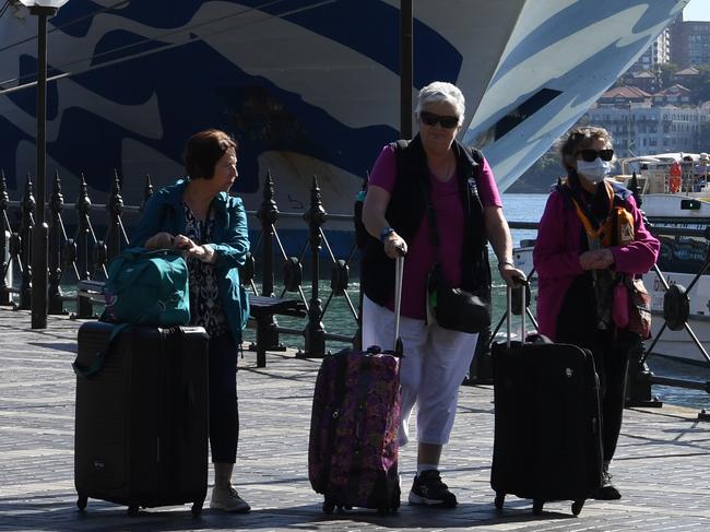 Cruise ship passengers disembark from the Princess Cruises owned Ruby Princess at Circular Quay in Sydney, Thursday, March 19, 2020. (AAP Image/Dean Lewins) NO ARCHIVING