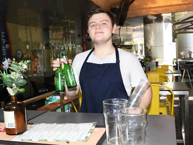 Trae Buckland collects empties at The Deck Bar ... licensed venues across Darwin have been left feeling short-changed after council lifted alfresco fees, but for unlicensed venues only. Picture: Katrina Bridgeford