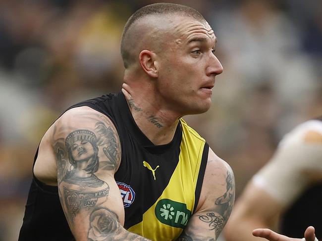 MELBOURNE, AUSTRALIA - AUGUST 19: Dustin Martin of the Tigers handballs under pressure from Paul Curtis of the Kangaroos during the round 23 AFL match between Richmond Tigers and North Melbourne Kangaroos at Melbourne Cricket Ground, on August 19, 2023, in Melbourne, Australia. (Photo by Daniel Pockett/Getty Images)