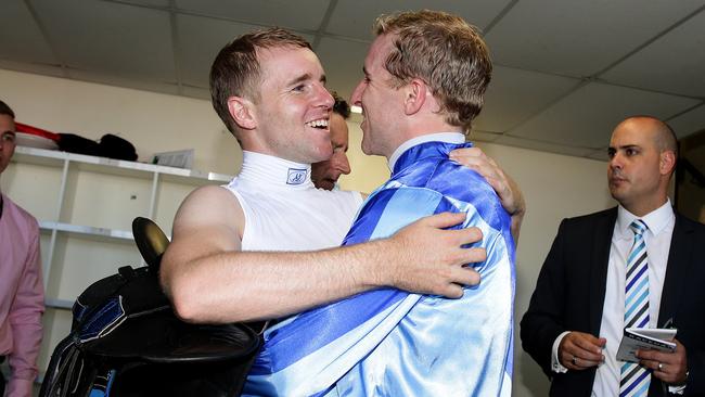 Jockey Nathan Berry rides no1 Unencumbered to the win in the Magic Millions 2YO Classic on the Gold Coast and is hugged by twin brother Tommy Berry as he enters the Jockeys room. Pics Adam Head