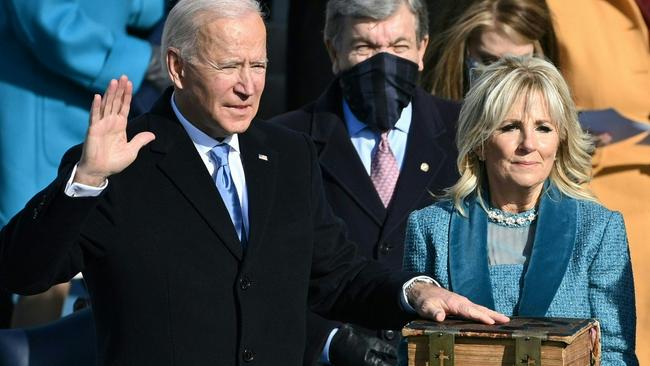 Mr Biden, with Dr Biden, takes the oath of office as the 46th US president during the swearing-in ceremony at the US Capitol in Washington.