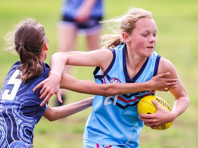 Victoria's Chloe Bilucaglia tackles NSW's Andie Pieper on Day two of the School Sport Australia U12 Australian Football Championships, VIC v NSW (Girls), on August 8th, 2022, at the Parade in Norwood.Picture: Tom Huntley