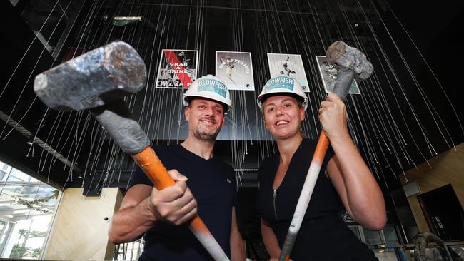 Steven and Autumn Adams rolled up their sleeves to get Blowfish opened. Picture: Glenn Hampson