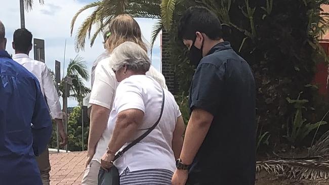 Brendan Piccini (pictured here in black) walks out of Lismore District Court with a large group of supporters.