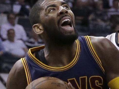 Cleveland Cavaliers’ Kyrie Irving (2) drives around San Antonio Spurs’ Tony Parker (9) during the first half of an NBA basketball game, Thursday, March 12, 2015, in San Antonio. (AP Photo/Eric Gay)