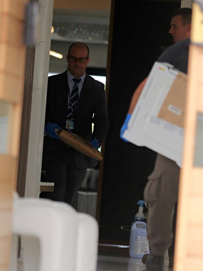 Police carried bags out of the house. Picture: John Grainger