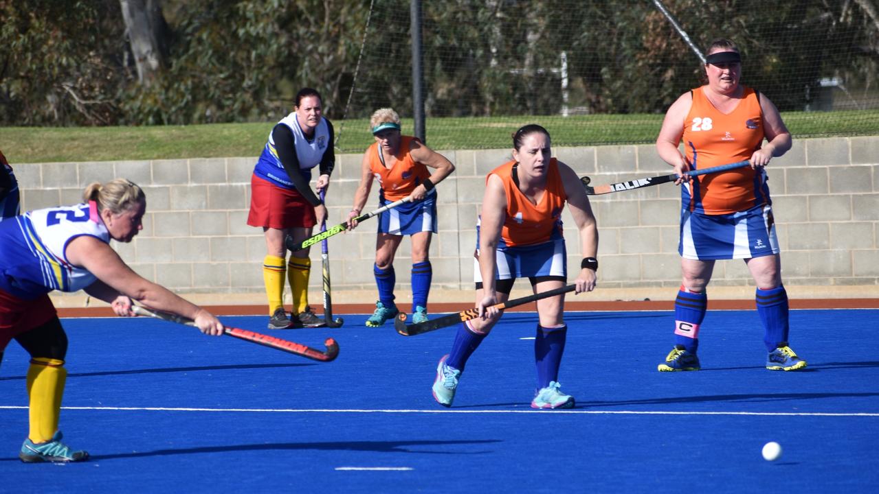 Maryborough players Mel Wyatt and Marion Millard line up the ball in their clash against Brisbane at the 2021 Queensland Hockey Women's Masters Championships.