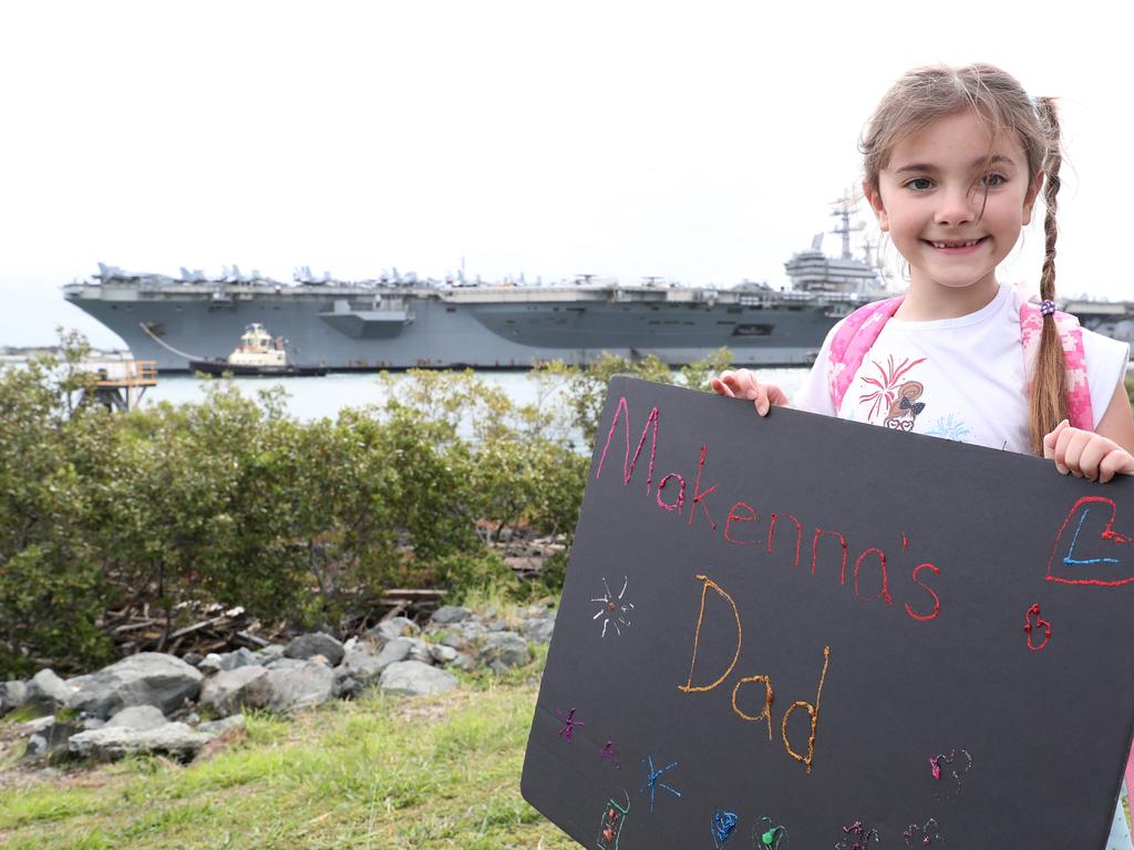 Makenna Klein (6) waves at the ship looking for her dad. The USS Ronald Reagan arrives in Brisbane. Pic Peter Wallis