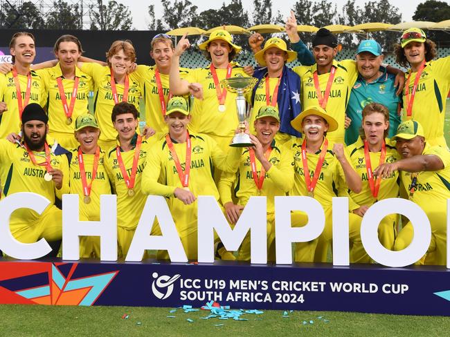 BENONI, SOUTH AFRICA - FEBRUARY 11: Hugh Weibgen, Captain of Australia, and Harry Dixon lift the ICC U19 MenÃ¢â¬â¢s Cricket World Cup trophy as players of Australia pose for a team photograph with the Ã¢â¬ÅChampionsÃ¢â¬Â winners board after the ICC U19 MenÃ¢â¬â¢s Cricket World Cup trophy after defeating India during the ICC U19 Men's Cricket World Cup South Africa 2024 Final between India and Australia at Willowmoore Park on February 11, 2024 in Benoni, South Africa. (Photo by Lee Warren/Gallo Images/Getty Images)