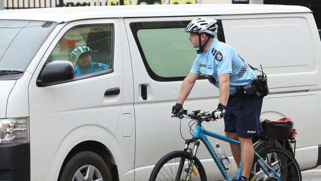 Senior Constable Uwe Stolzenberg checks on a van driver. Picture: David Crosling