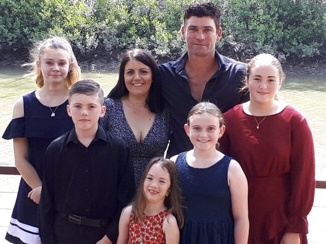 Ava at the front of a family photo. (L to R) Madison, 14; Matthew, 12; mother Tiffiany; Ava, 8; father Jeremy; Isabell, 11; and, Caitlyn, 13.