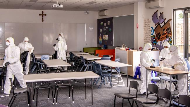 Workers clean a classroom at St Christopher's Catholic Primary. Picture: Monique Harmer