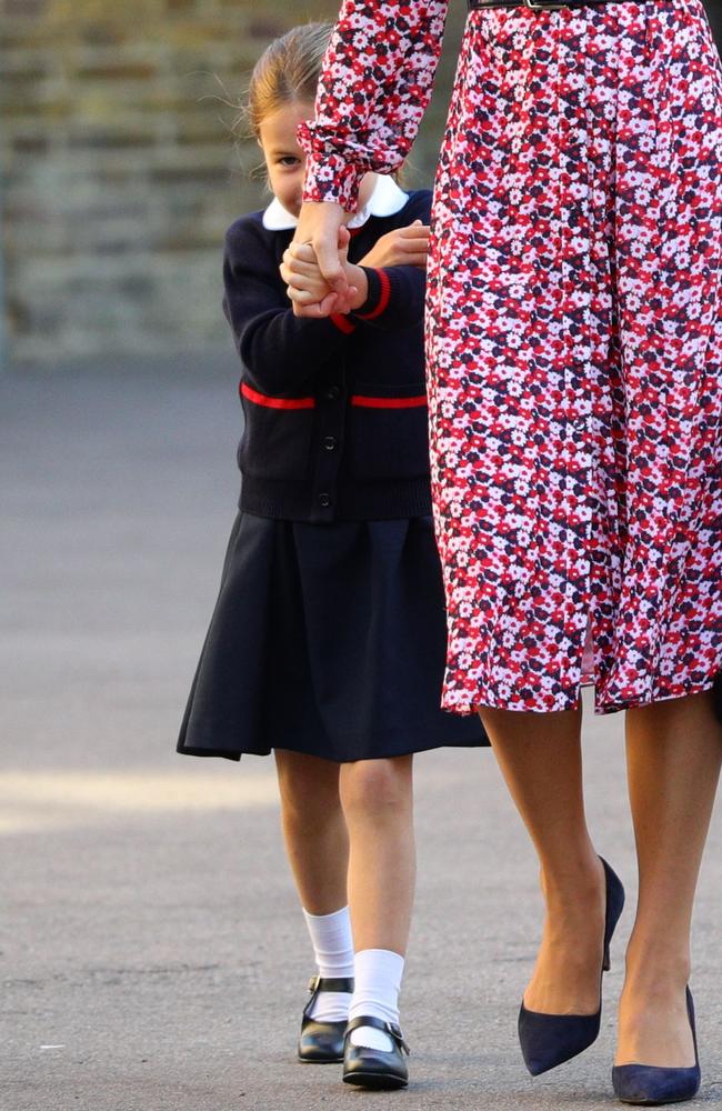 Charlotte nervously hid behind her mum as she walked up to the school. Picture: Aaron Chown/AFP