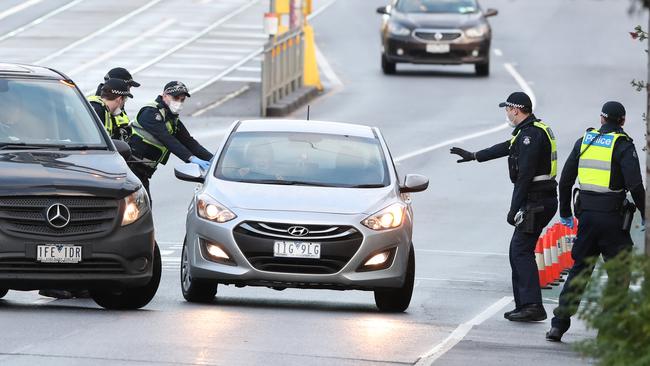 Police speak to motorists before they drive into the tower blocks. Picture: David Crosling