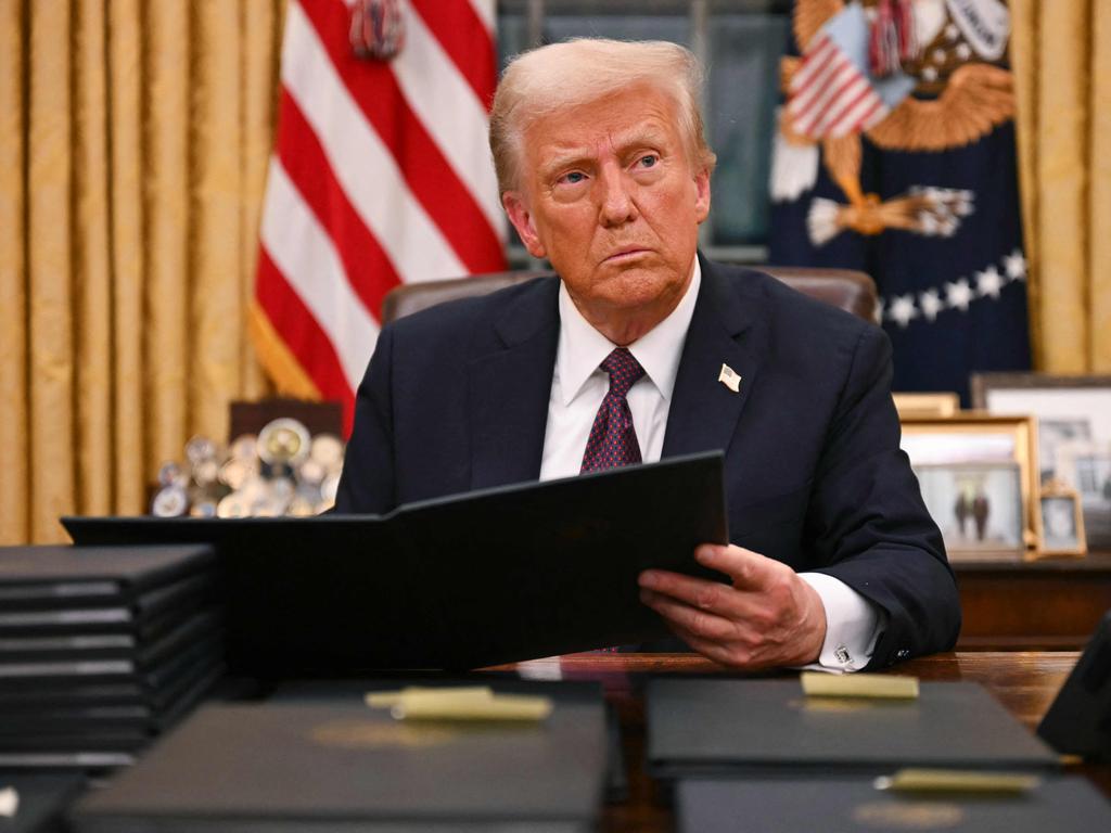 US President Donald Trump went on a signing spree, signing stacks of executive orders in the Oval Office of the White House and at a rally on January 20, 2025, hours after his inauguration ceremony. Picture: Jim Watson/AFP