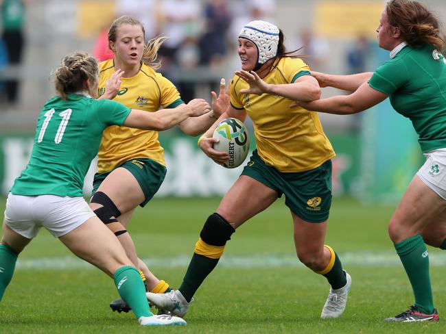 BELFAST, NORTHERN IRELAND - AUGUST 22:  Sharni Williams of Australia is tackled by Alison Miller (L) and Ailis Egan during the Women's Rugby World Cup 2017 match between Ireland and Australia at the Kingspan Stadium on August 22, 2017 in Belfast, United Kingdom.  (Photo by David Rogers/Getty Images)