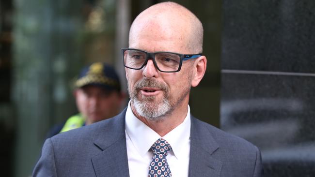 Former Victoria Police Chief Commissioner Simon Overland leaves the Royal Commission. Picture: AAP