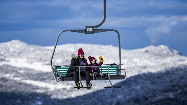 Jayd Arbalis and Zander, 5, from Canberra on the chair left at Thredbo, NSW. The 2020 snow season opens on Monday. Picture: Sean Davey.