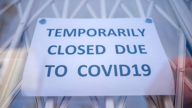 (FILES) In this file photo taken on June 01, 2020 A sign is seen in the window of a shop explaining to customers that it has temporarily closed due to the coronavirus outbreak in Portobello Market in west London, following the easing of the lockdown restrictions during the novel coronavirus pandemic. - Electoral success, Brexit, a global health crisis that left him near death, divorce, engagement and even a new baby. Boris Johnson has had an eventful 12 months in anyone's book. Johnson, 56, marks his first anniversary as Britain's prime minister on Friday, having had what one lawmaker described to the Guardian newspaper as a "hell of a year". But his toughest test could yet be to come, as the full impact of the coronavirus outbreak bites on the UK economy, which has been battered by three months of enforced shutdown. (Photo by Tolga AKMEN / AFP)