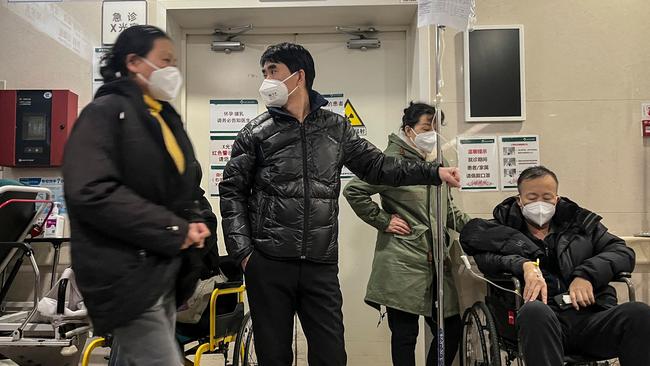 A patient in a wheelchair is treated in the emergency department of a hospital in Beijing. Picture: AFP.