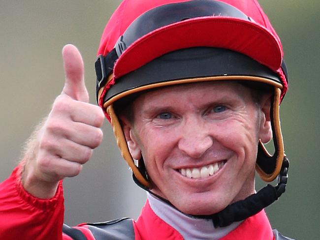 Jockey Glyn Schofield on Prized Icon gestures to trainer James Cummings after winning the Moet & Chandon Champagne Stakes race during the Schweppes All Aged Stakes Day at Royal Randwick racecourse in Sydney, Saturday, April 16, 2016. (AAP Image/David Moir) NO ARCHIVING, EDITORIAL USE ONLY