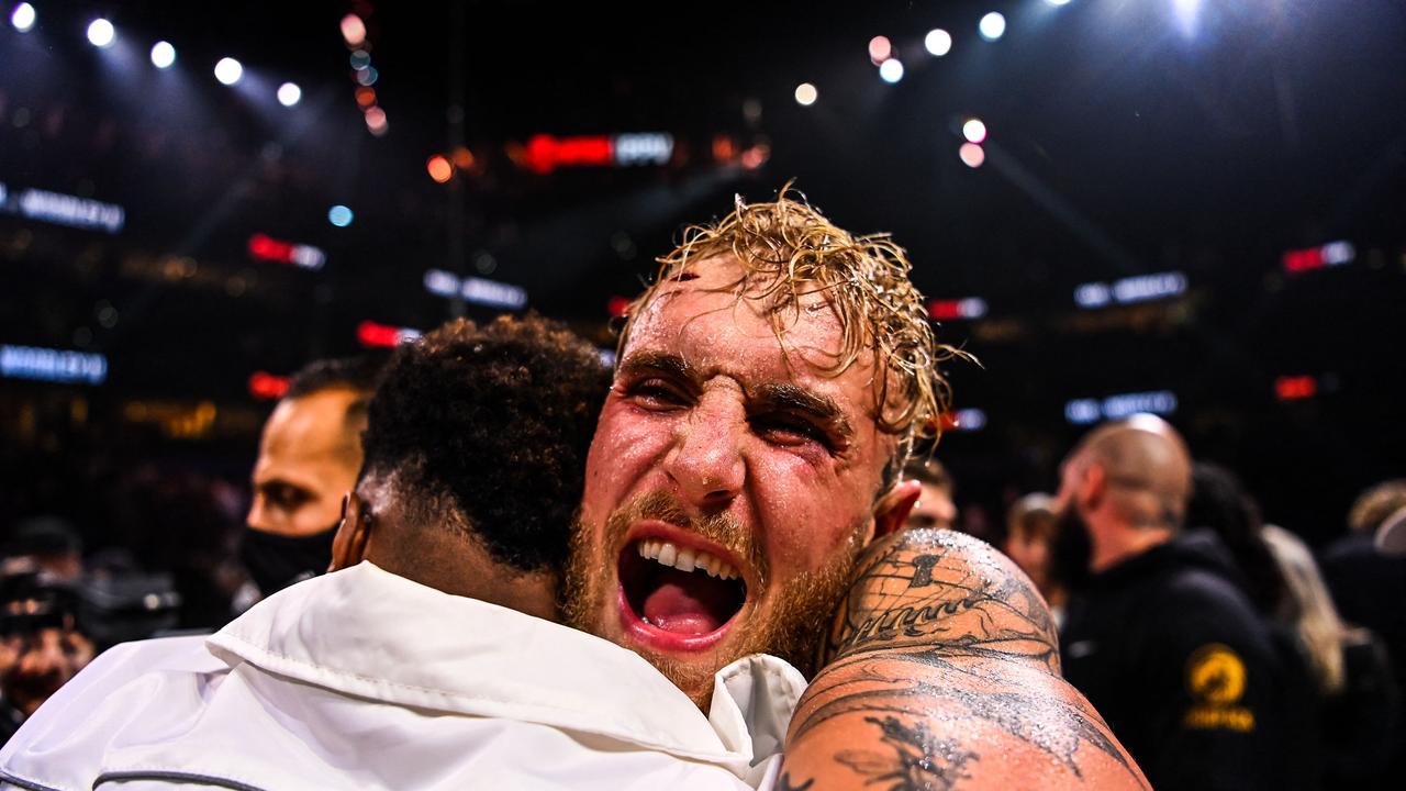 YouTube personality Jake Paul celebrates after knocking out former UFC welterweight champion Tyron Woodley during a fight at the Amalie Arena in Tampa, Florida, on December 18, 2021. (Photo by CHANDAN KHANNA / AFP)