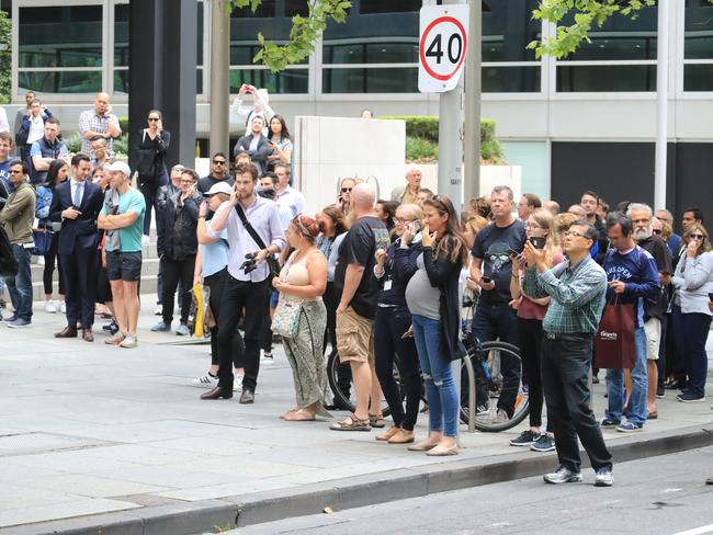 Bystanders watch on as emergency services tend to the injured. Picture: Alex Coppel