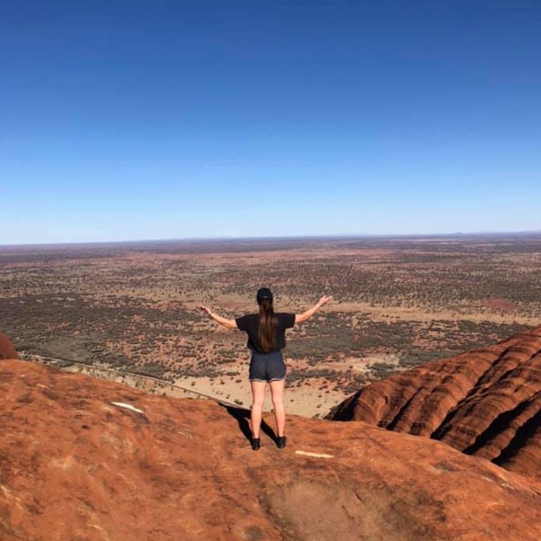 A tourist at the top of Uluru.