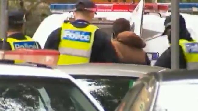 A man is arrested trying to flee the locked-down housing towers in Flemington. Picture: Channel 10