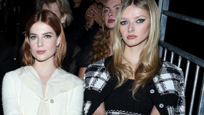 Apple Martin (right) sitting in the front row of the Chanel couture shows in Paris alongside Lucy Boynton. Picture: Pascal Le Segretain/Getty Images