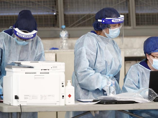 MELBOURNE, AUSTRALIA - JUNE 29:  ADF (Australian Defence Force) personnel assist with a COVID-19 testing at Melbourne Showgrounds on June 29, 2020 in Melbourne, Australia. Victoria has recorded 75 new coronavirus cases overnight, the state's fourth-highest single day rise since the start of the pandemic, while increased testing in Melbourne suburbs that have been identified as community transmission hotspots for coronavirus continues. Restrictions in Victoria have been tightened in response to the spike in new cases across the state with premier Daniel Andrews extending the current state of emergency for at least four weeks to allow police the power to enforce social distancing rules. (Photo by Darrian Traynor/Getty Images)