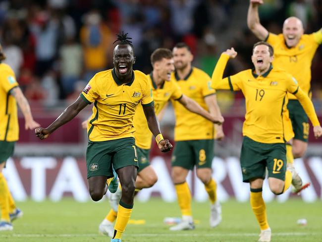 DOHA, QATAR - JUNE 13: Awer Mabil and team mates of Australia celebrate their sides victory after a penalty shoot out following the 2022 FIFA World Cup Playoff match between Australia Socceroos and Peru at Ahmad Bin Ali Stadium on June 13, 2022 in Doha, Qatar. (Photo by Mohamed Farag/Getty Images)