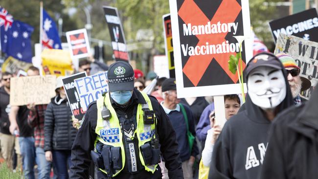 This police officer was one of the few in attendance wearing a medical face mask. Picture: Emma Brasier