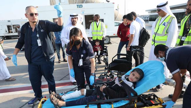 Volunteers transport a wounded Palestinian child off the plane upon their arrival in Abu Dhabi on November 18, after being evacuated from Gaza as part of a humanitarian mission organised by the United Arab Emirates. Picture: AFP