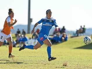 South West Queensland Thunder striker Louise Rolfe (right) breaks away from the Brisbane Roar defence. Rolfe scored in the Thunder's 4-1 defeat to the Roar. Picture: Kevin Farmer