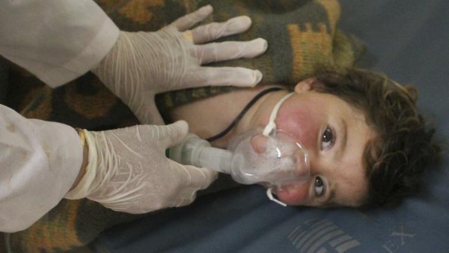 A Syrian doctor treating a child following a suspected chemical attack, at a makeshift hospital, in the town of Khan Sheikhun, northern Idlib province, Syria. Picture: AP/Edlib Media Centre