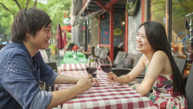 A young couple enjoy Australian wine at a bar in Beijing. Picture: Shannon Fagan